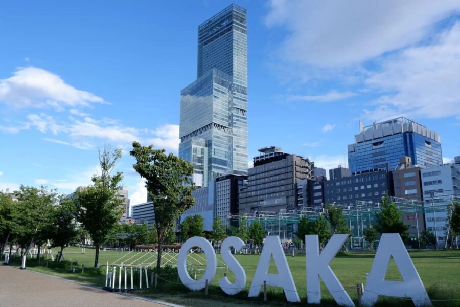 Osaka cityscape featuring skyscrapers and green park space, embodying urban vibrancy and modern architecture.