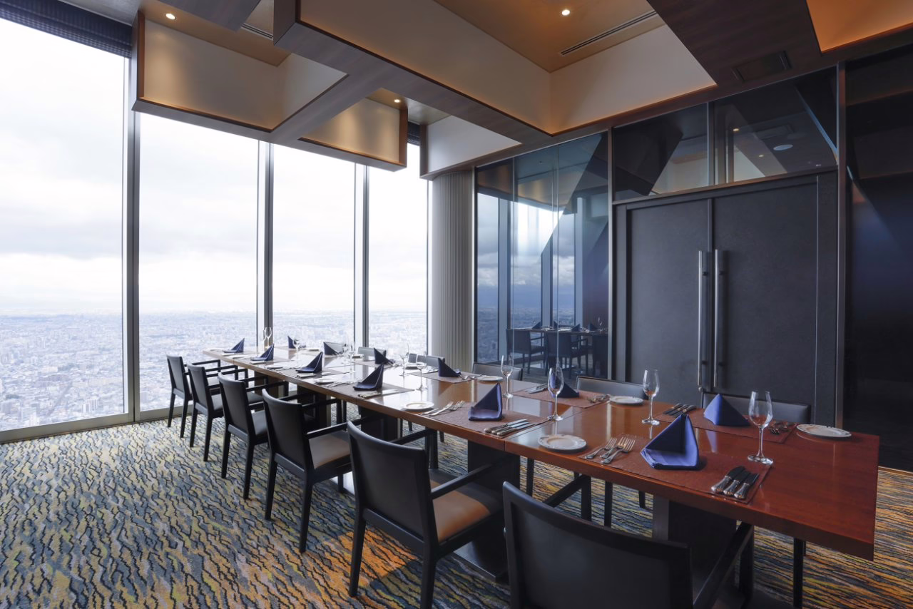 Elegant dining room with panoramic city views, perfect for upscale events and memorable dining experiences.