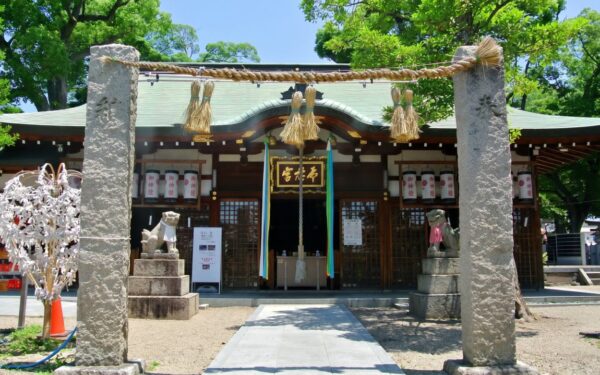 Serene Shinto shrine entrance adorned with traditional decor, inviting visitors to explore Japanese spiritual heritage and culture.