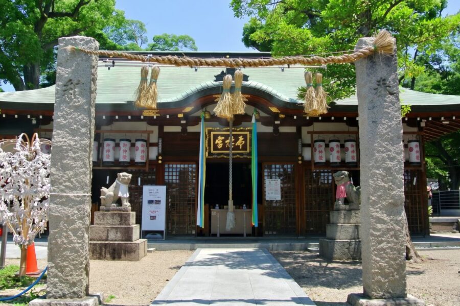 Serene Shinto shrine entrance adorned with traditional decor, inviting visitors to explore Japanese spiritual heritage and culture.