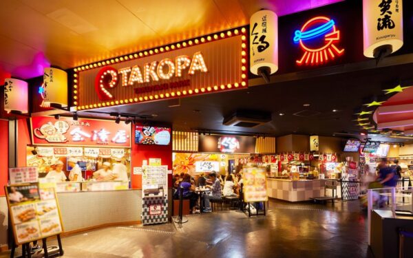 Vibrant Takoyaki Park showcasing various food stalls and diners enjoying Japanese street food in a lively setting.