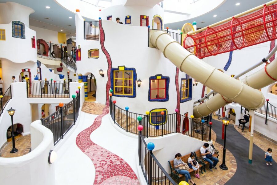 Kids Plaza Osaka: Colorful indoor playground featuring winding paths, slides, and playful architecture, designed for children's enjoyment and exploration.